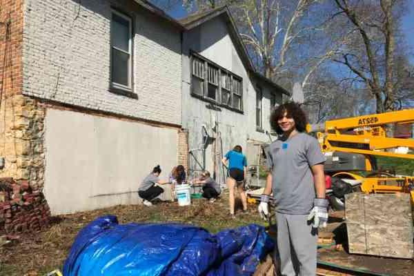 Students helping fix a house